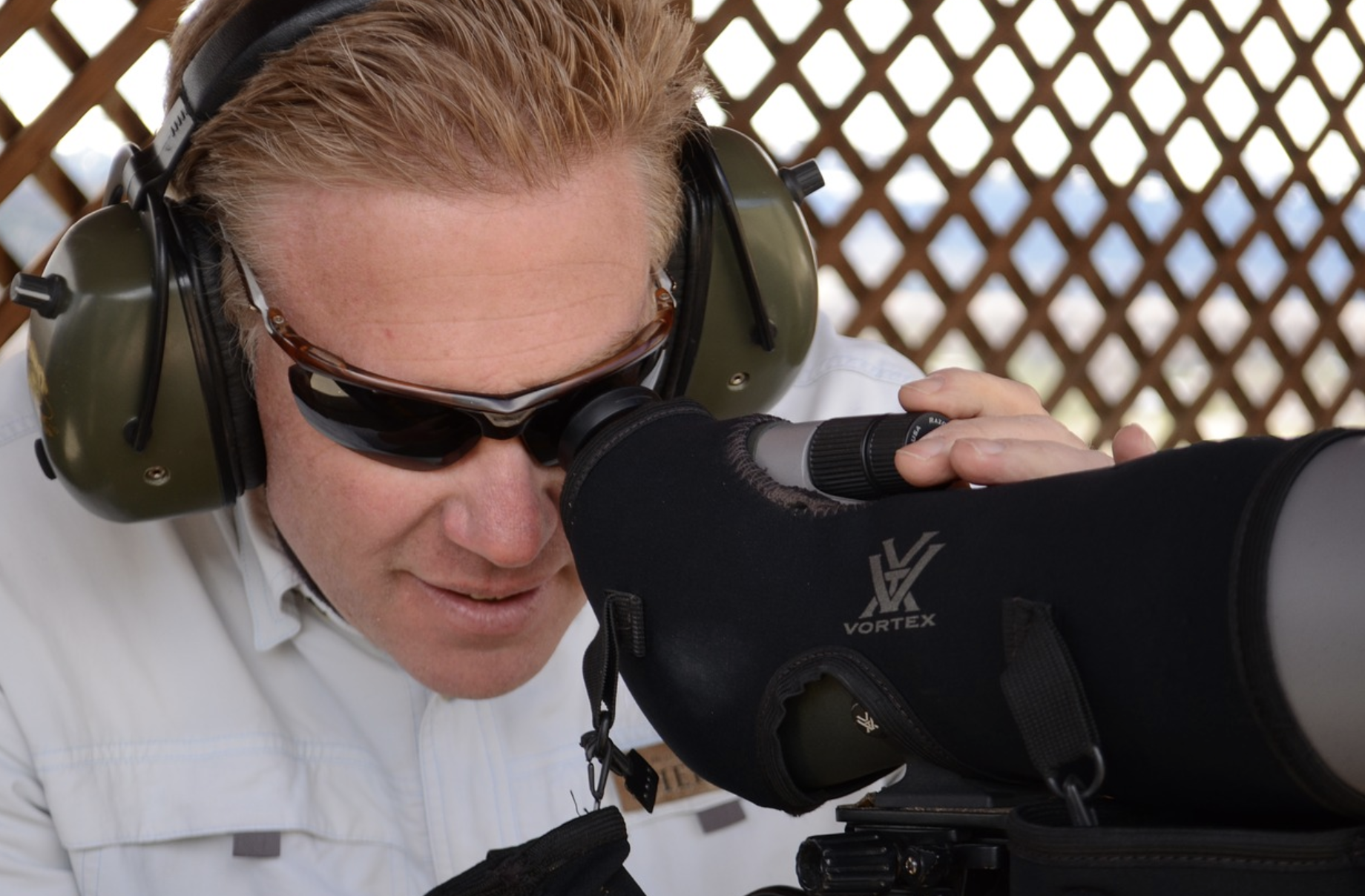 man looking through a rifle scope