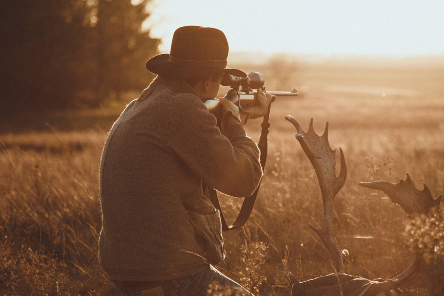 hunter aiming on a sight scope